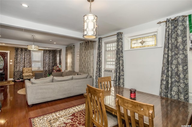 dining space featuring radiator, dark hardwood / wood-style floors, and cooling unit