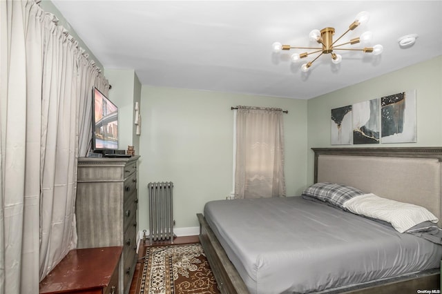 bedroom featuring radiator and a notable chandelier