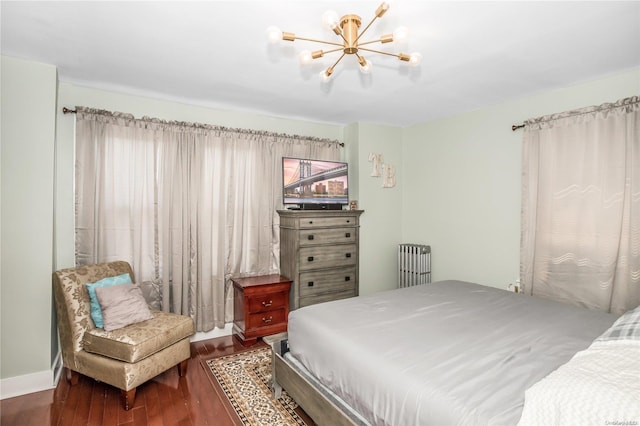 bedroom featuring dark hardwood / wood-style floors, radiator, and a chandelier