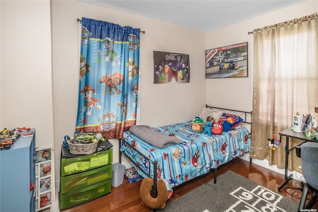 bedroom with dark hardwood / wood-style flooring