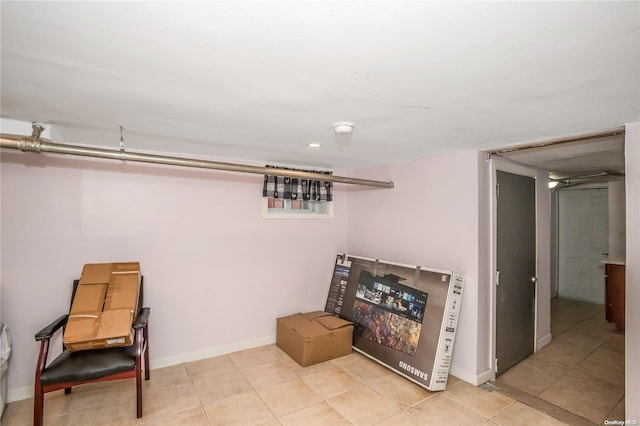 basement featuring light tile patterned flooring