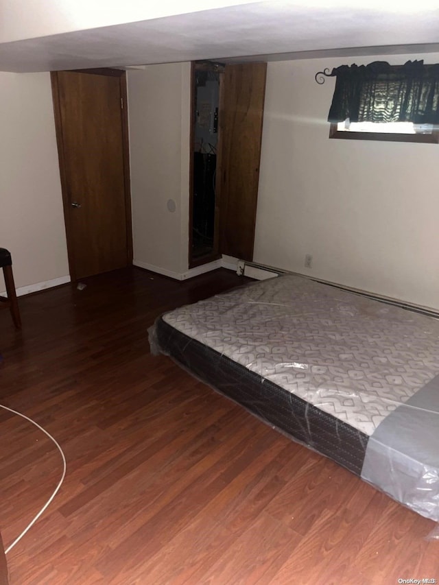 unfurnished bedroom featuring dark hardwood / wood-style flooring