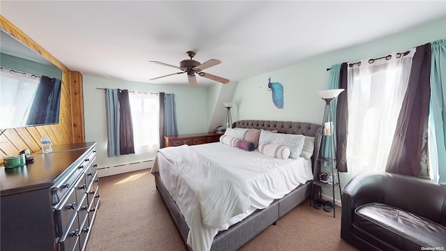 carpeted bedroom with ceiling fan and a baseboard heating unit