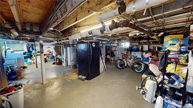 basement featuring black fridge and water heater