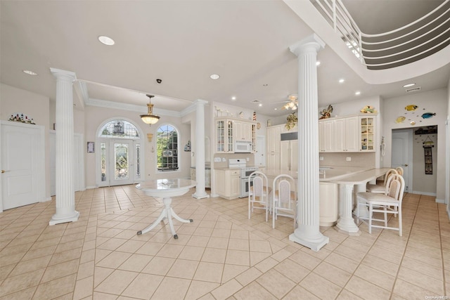 interior space featuring light tile patterned floors, ceiling fan, and ornamental molding