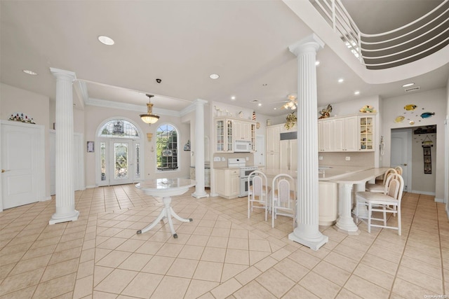 48 S Old Neck Rd, Center Moriches, NY 11934 - entryway featuring decorative columns, light tile patterned flooring, recessed lighting, crown molding, and baseboards