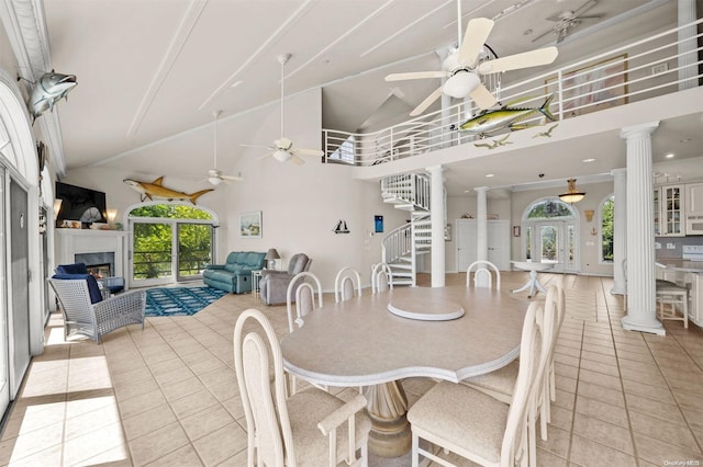48 S Old Neck Rd, Center Moriches, NY 11934 - dining area featuring decorative columns, a fireplace, ceiling fan, high vaulted ceiling, and light tile patterned flooring