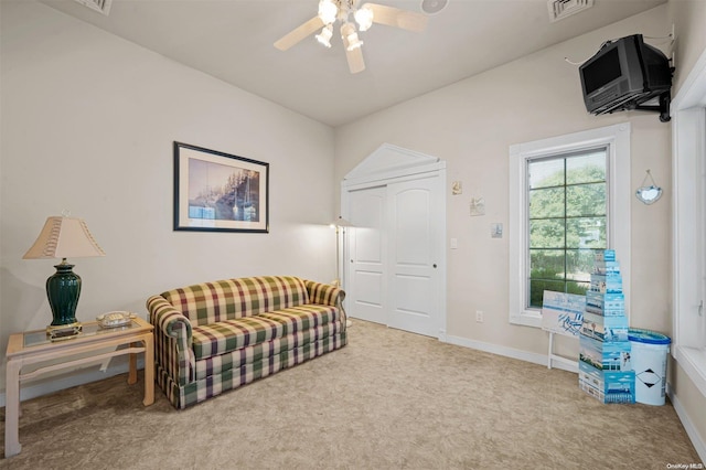 sitting room featuring light colored carpet and ceiling fan