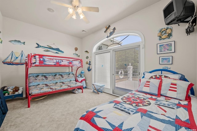 carpeted bedroom with access to exterior, ceiling fan, and vaulted ceiling