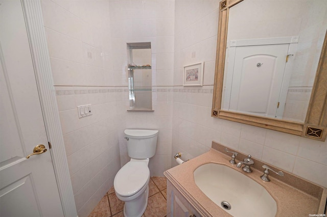 bathroom with vanity, toilet, tile walls, and tasteful backsplash