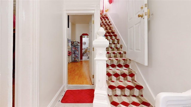 staircase featuring hardwood / wood-style flooring