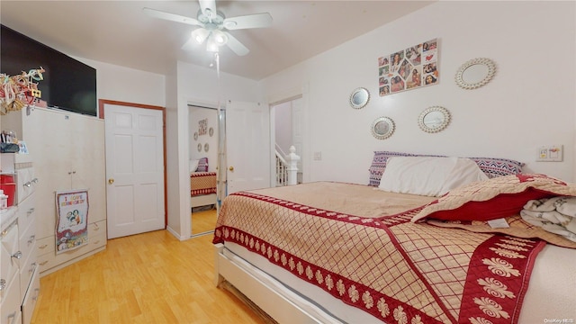 bedroom with ceiling fan and light hardwood / wood-style flooring