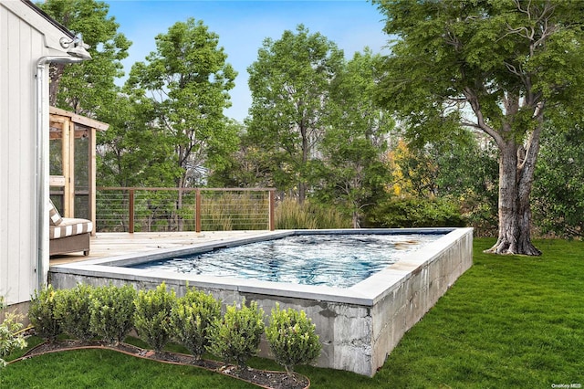 view of swimming pool featuring a lawn and a wooden deck