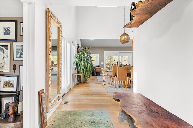 corridor with light hardwood / wood-style floors