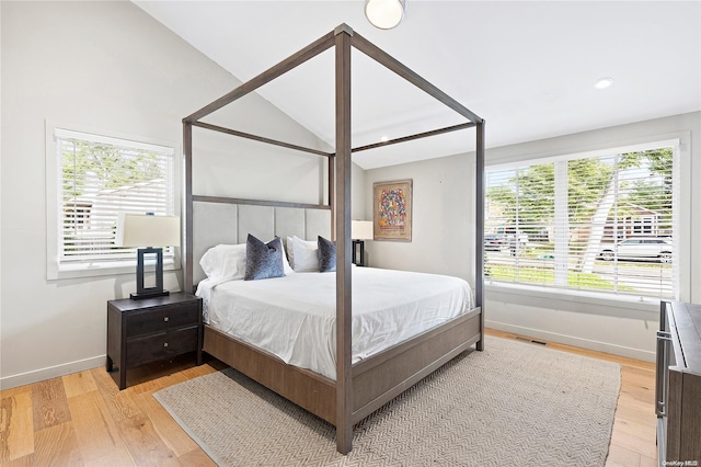 bedroom with light hardwood / wood-style floors and vaulted ceiling