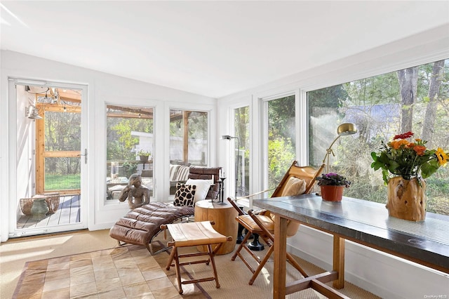 sunroom with a healthy amount of sunlight and vaulted ceiling