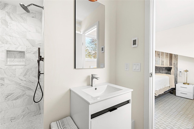 bathroom with vanity and tiled shower