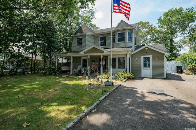 victorian-style house with a porch and a front yard