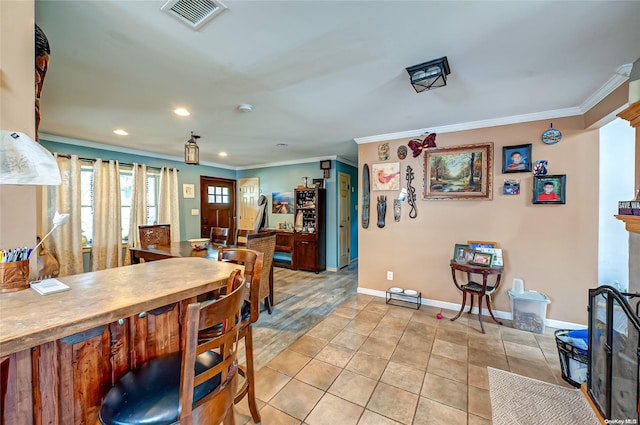 tiled dining area featuring ornamental molding