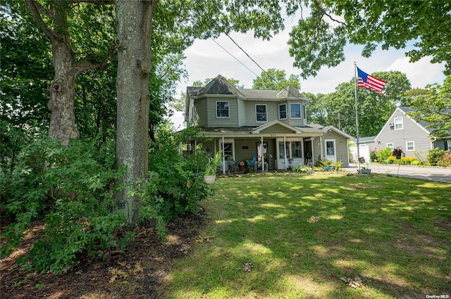 view of front of home with a porch and a front lawn