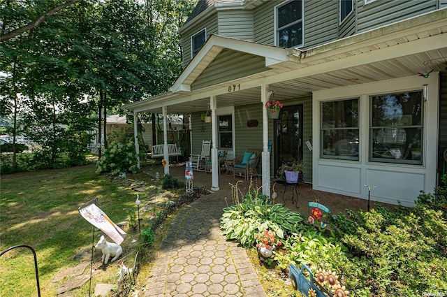 exterior space featuring a porch and a lawn