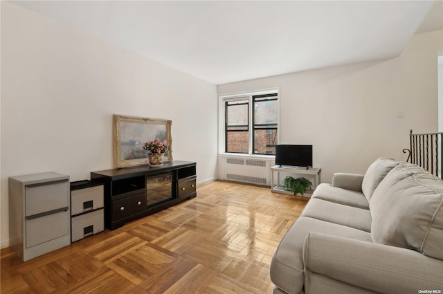 living room with radiator heating unit and light parquet flooring