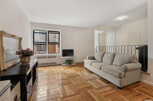 living room featuring light parquet flooring and radiator