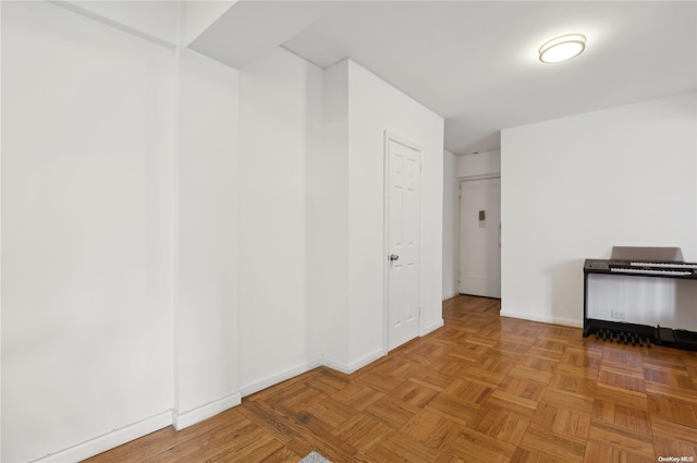 unfurnished room featuring parquet flooring