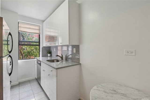 kitchen with decorative backsplash, sink, white cabinetry, and stainless steel appliances