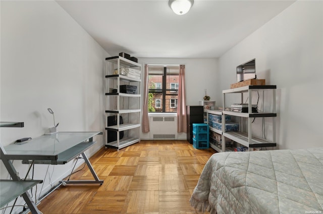 bedroom featuring light parquet floors and radiator