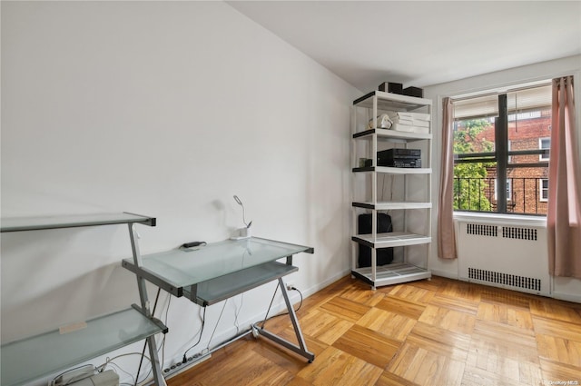 office area with radiator heating unit and light parquet flooring