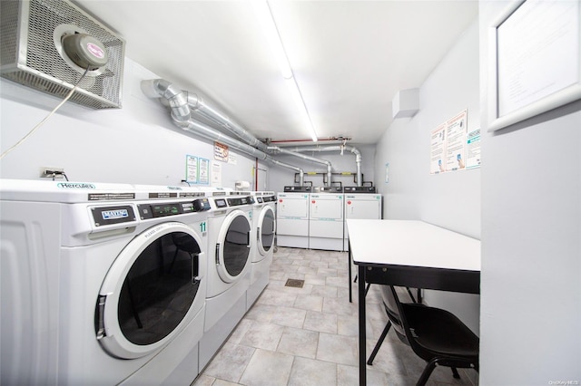 clothes washing area with washing machine and dryer