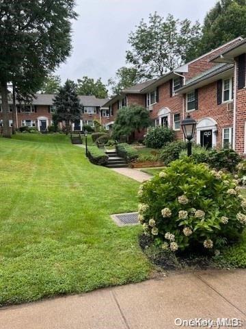 view of home's community featuring a lawn