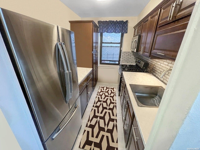 kitchen with decorative backsplash, sink, dark brown cabinets, and appliances with stainless steel finishes