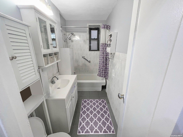 full bathroom featuring tile patterned flooring, vanity, shower / bath combo, and toilet