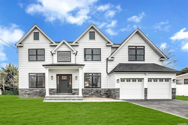 view of front of house featuring a garage and a front lawn