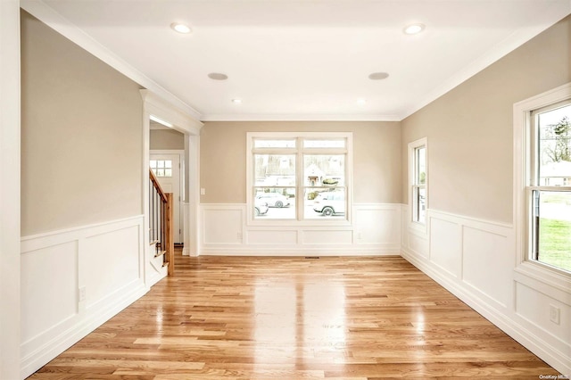 interior space featuring a healthy amount of sunlight, crown molding, and light hardwood / wood-style flooring