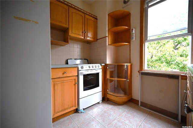 kitchen featuring white appliances, light tile patterned floors, and tasteful backsplash