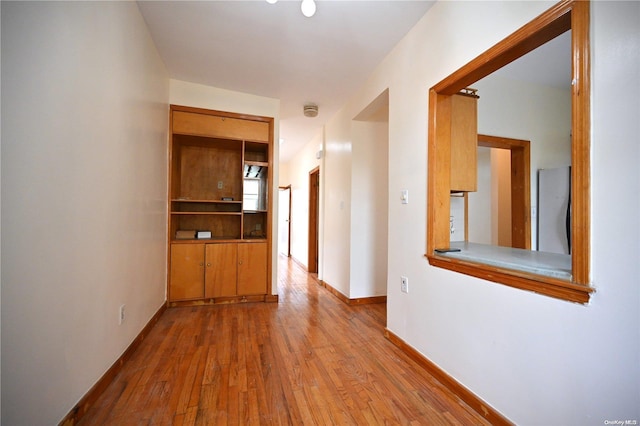 hallway with wood-type flooring