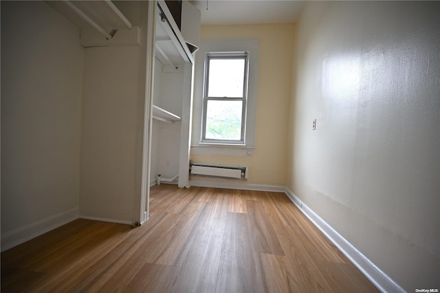 interior space with hardwood / wood-style floors and a baseboard radiator