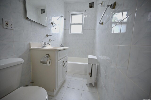 full bathroom featuring tile patterned floors, vanity, toilet, and tile walls