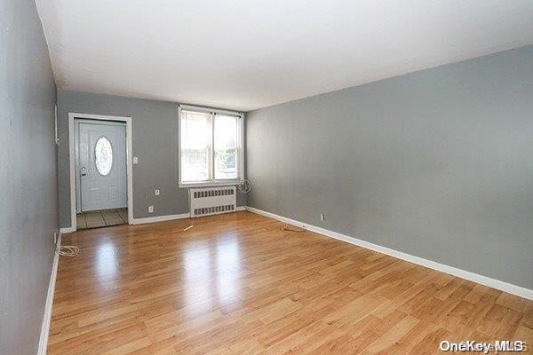 entryway featuring light hardwood / wood-style floors and radiator