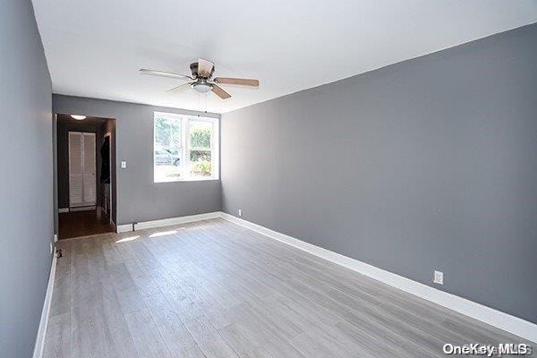 unfurnished room featuring light hardwood / wood-style floors and ceiling fan