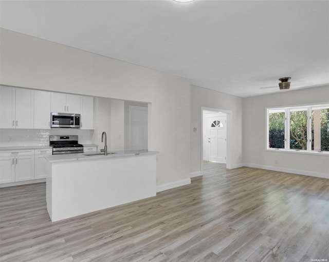2 Oak Ct, Staten Island, NY 10308 - kitchen featuring appliances with stainless steel finishes, a sink, light countertops, and light wood-style floors