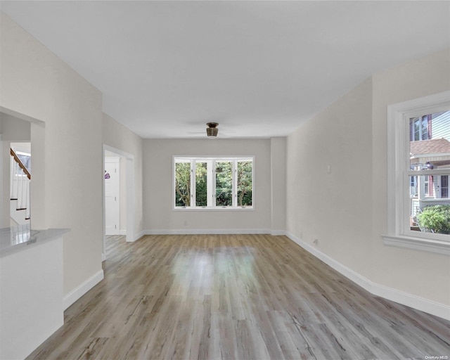 2 Oak Ct, Staten Island, NY 10308 - empty room featuring light wood finished floors, baseboards, stairs, and ceiling fan