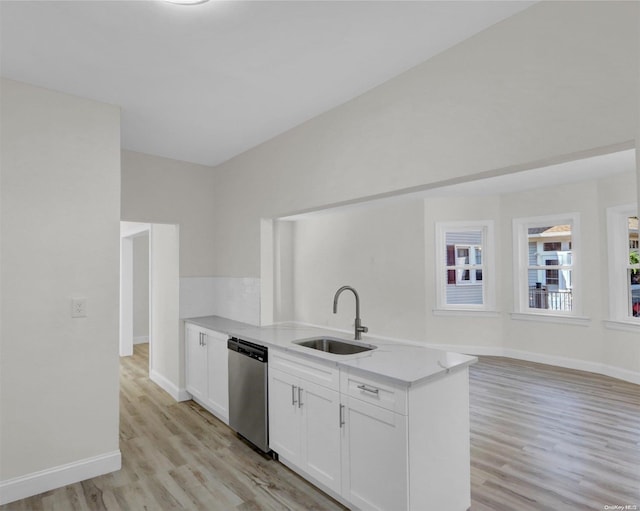 2 Oak Ct, Staten Island, NY 10308 - kitchen with dishwasher, a sink, light wood-style flooring, white cabinets, and light stone counters