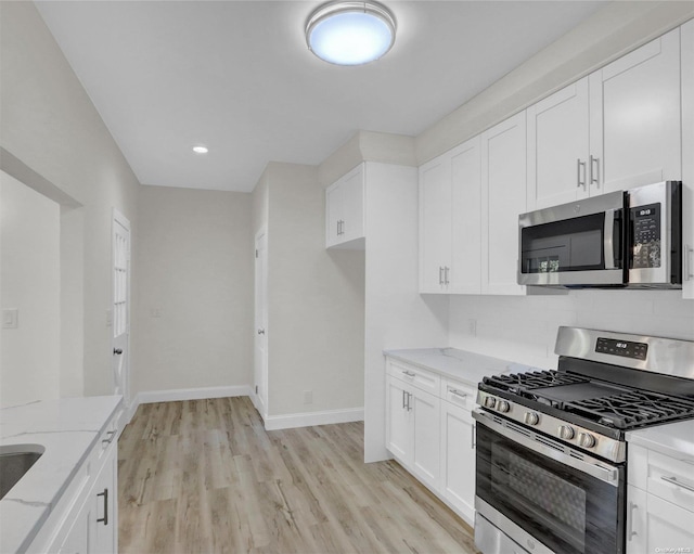 2 Oak Ct, Staten Island, NY 10308 - kitchen with appliances with stainless steel finishes, light stone countertops, light wood-style flooring, white cabinetry, and recessed lighting