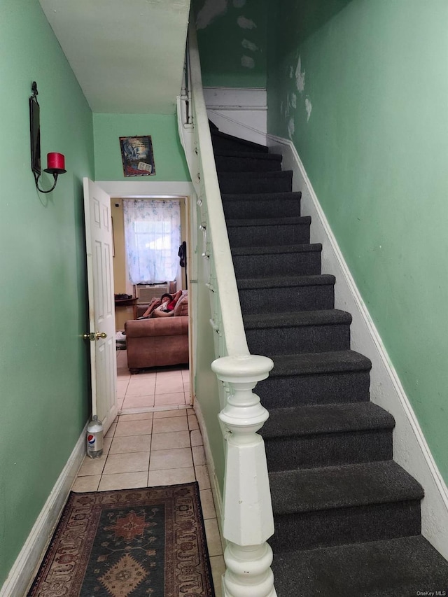 stairway with tile patterned floors