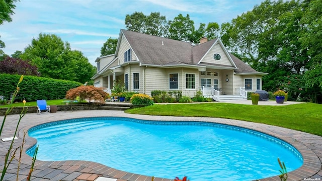 rear view of property with a patio area and a yard