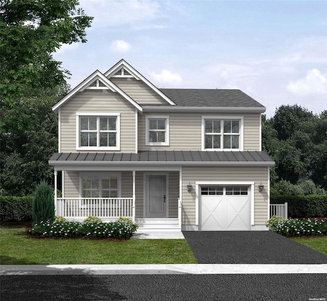 view of front of property with a garage and a front lawn